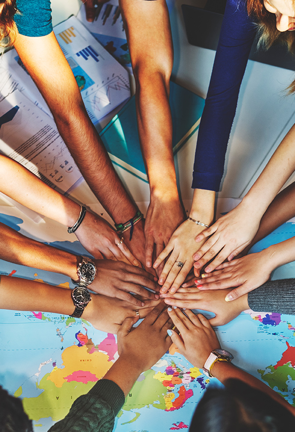 Group touching hands in solidarity